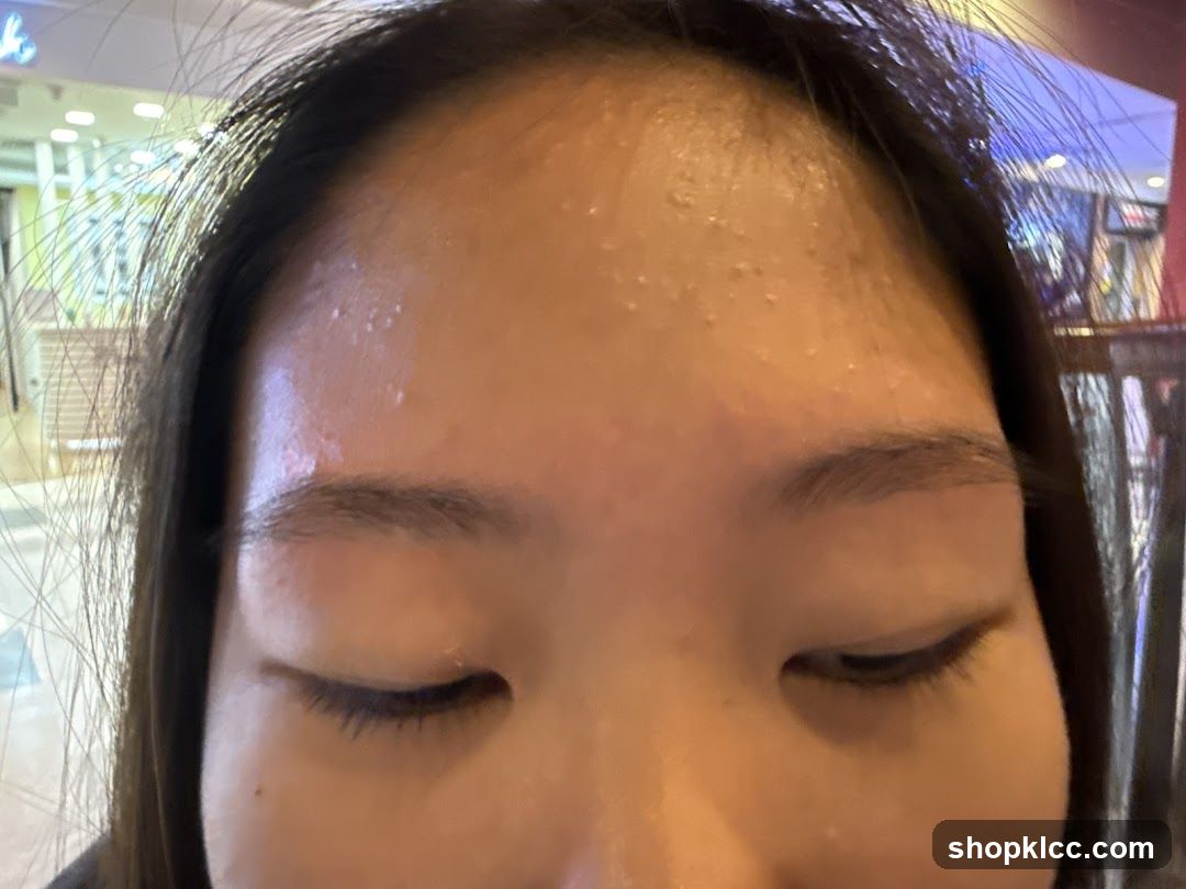 Close-up of forehead and eyes with visible sweat or moisture on skin