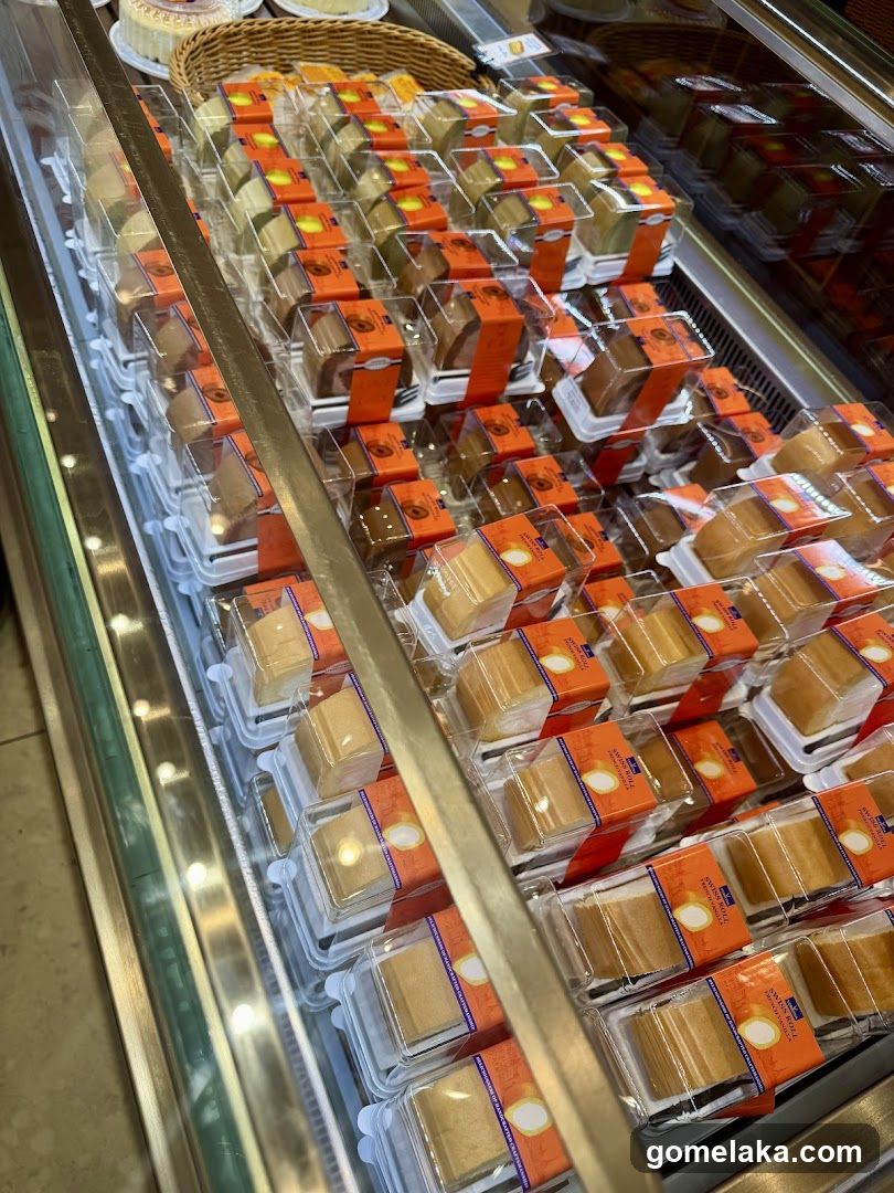 Display of packaged cakes in refrigerated case