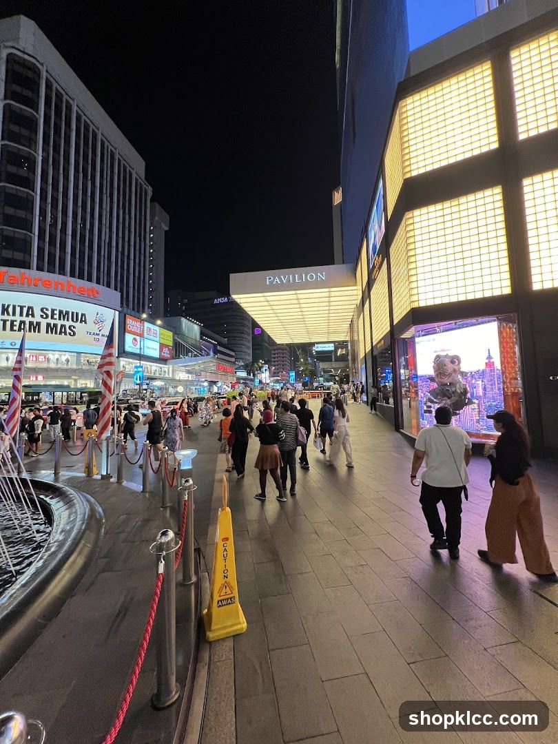 Busy street at night with illuminated buildings and crowds