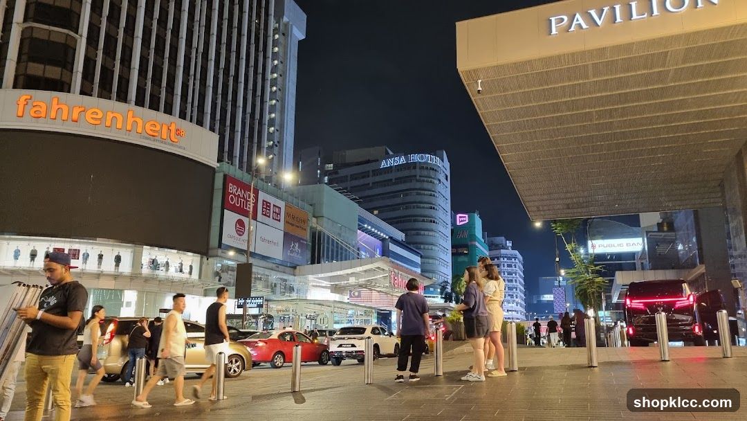 Night view of a busy street with shops and hotels