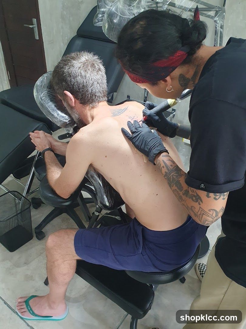 Tattoo Artist Working on Client