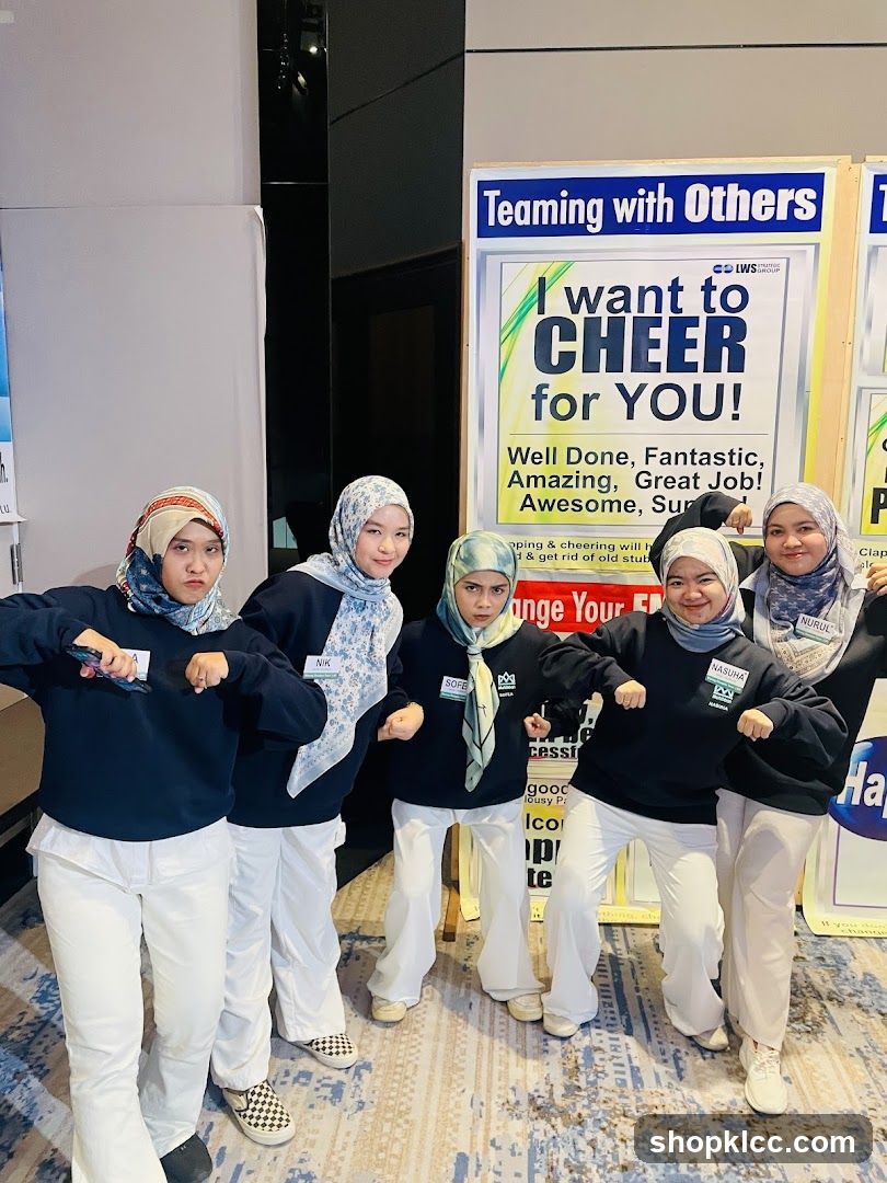 Team posing with motivational posters