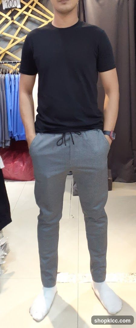 Man in black t-shirt and grey pants
