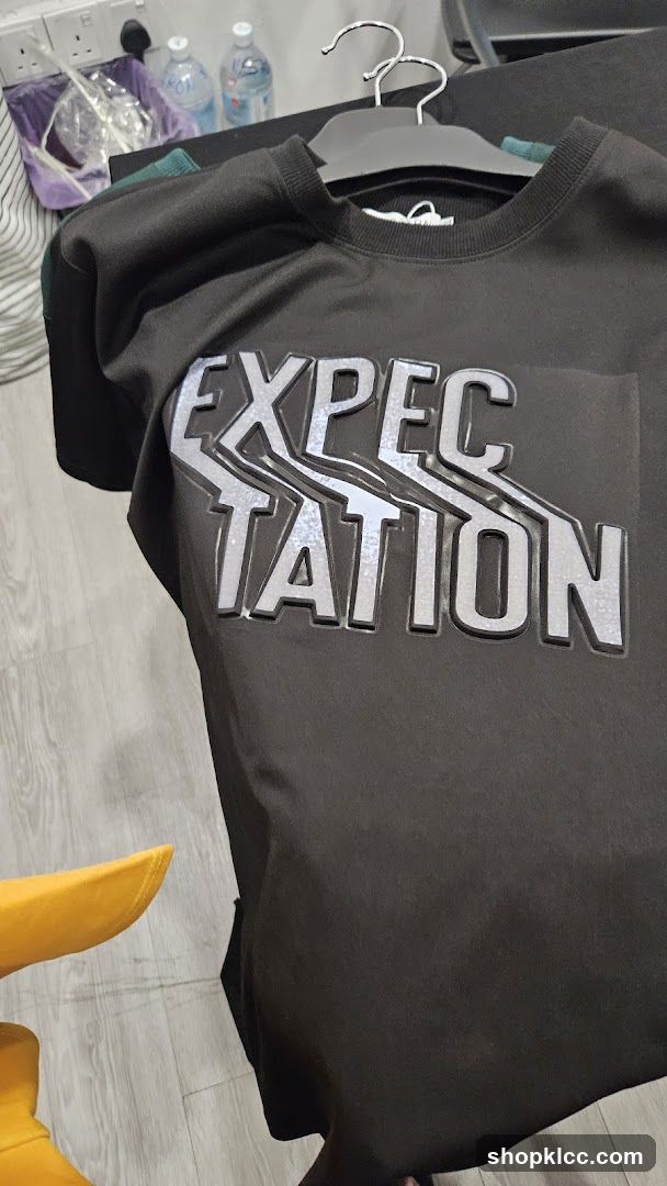 Black sweatshirt with "Expectation" graphic