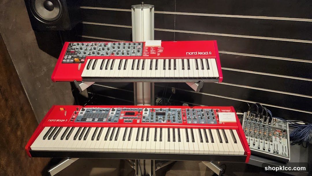 Two red synthesizers on display