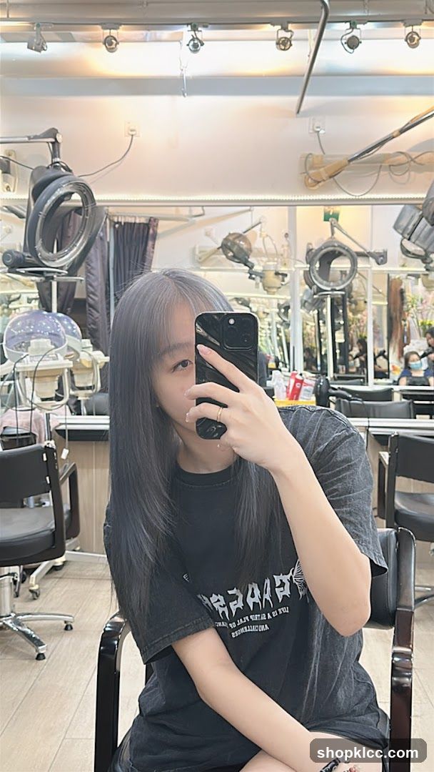 Woman taking a selfie in a hair salon