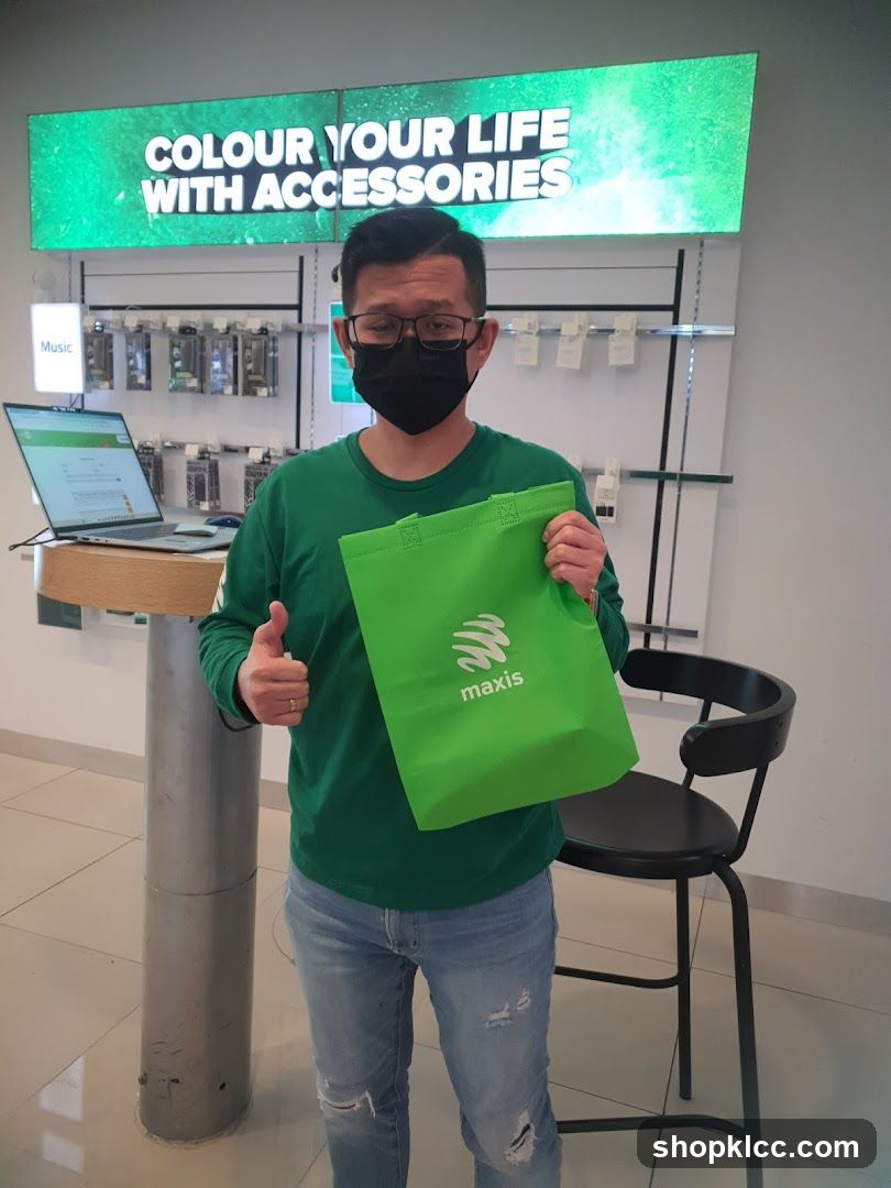 Man holding a green bag with a logo