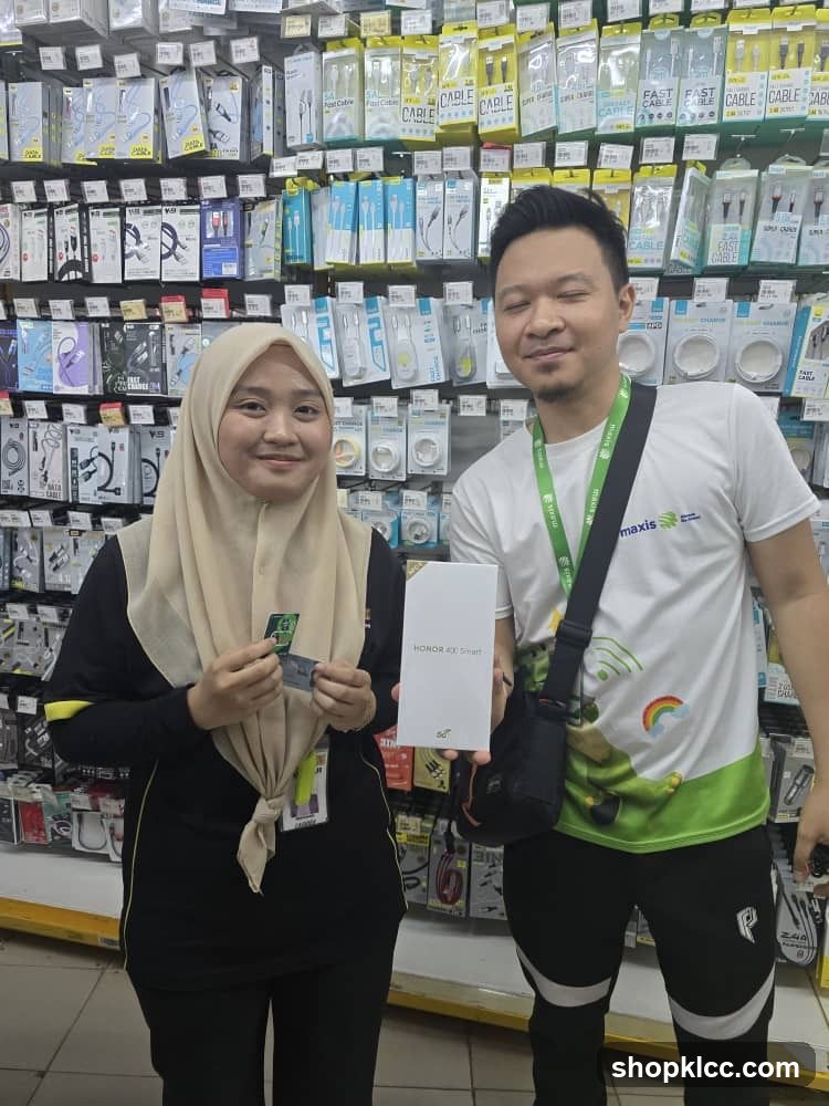 Two people in a store with shelves of accessories