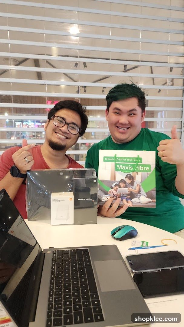 Two men with products and a brochure