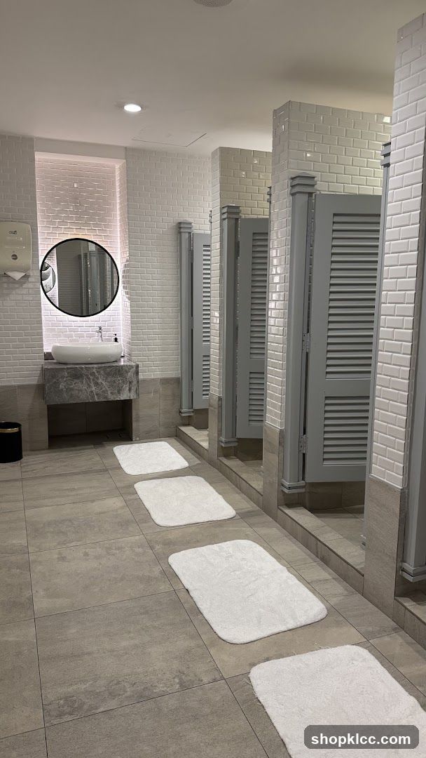 Modern Restroom with Stalls and Sink Area