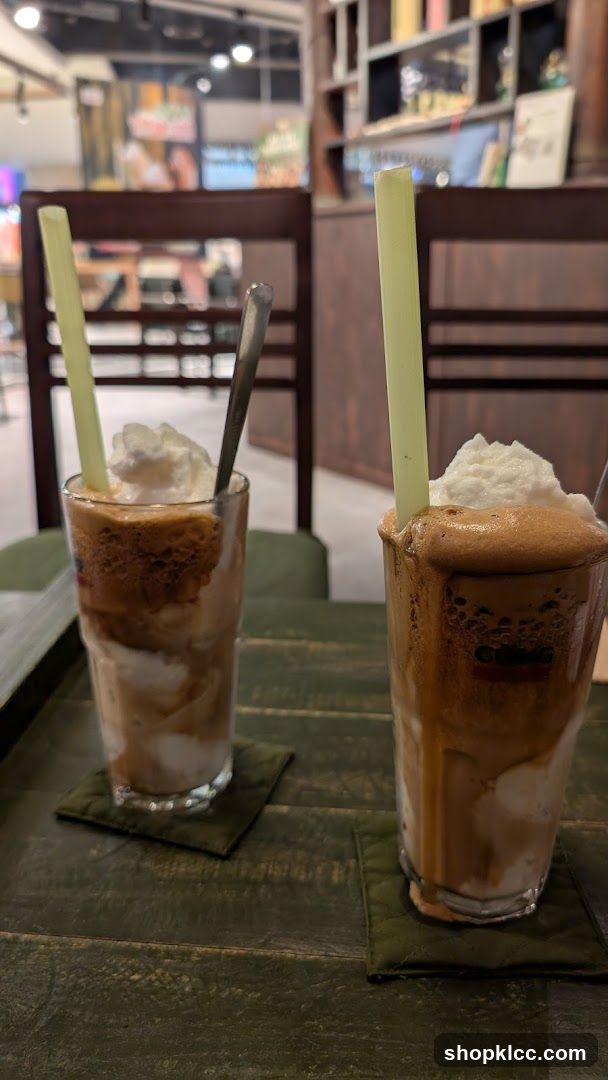 Two iced coffee drinks with whipped cream
