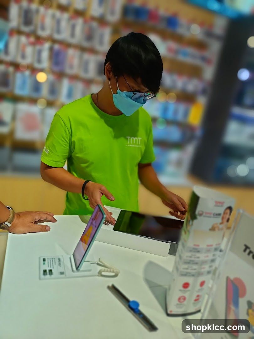 Salesperson assisting customer with a tablet