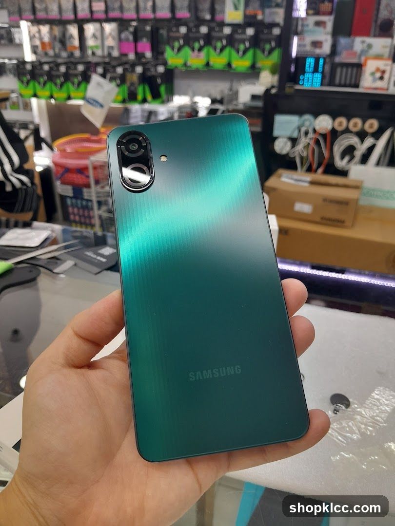 Hand holding a green Samsung smartphone