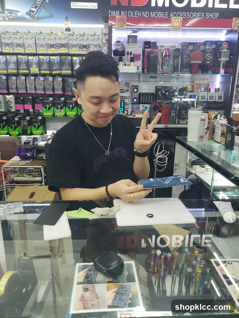 Man working at a mobile accessories shop