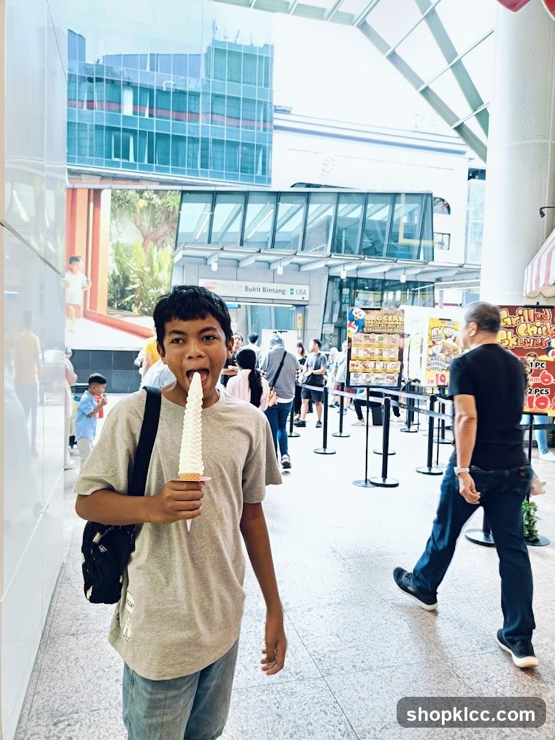 Boy eating ice cream in mall