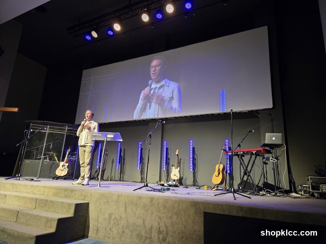 Speaker on Stage with Large Screen