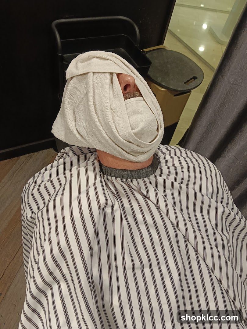 Man with towel on face