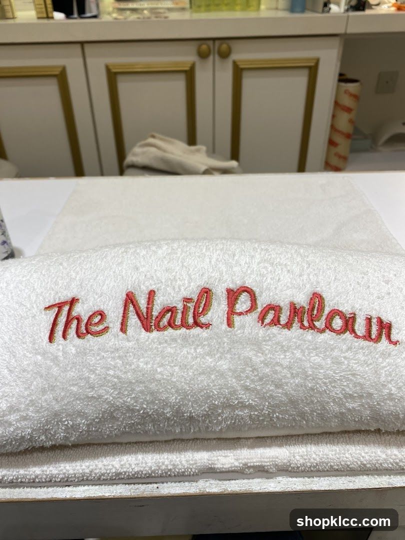 Towel with "The Nail Parlour" embroidered