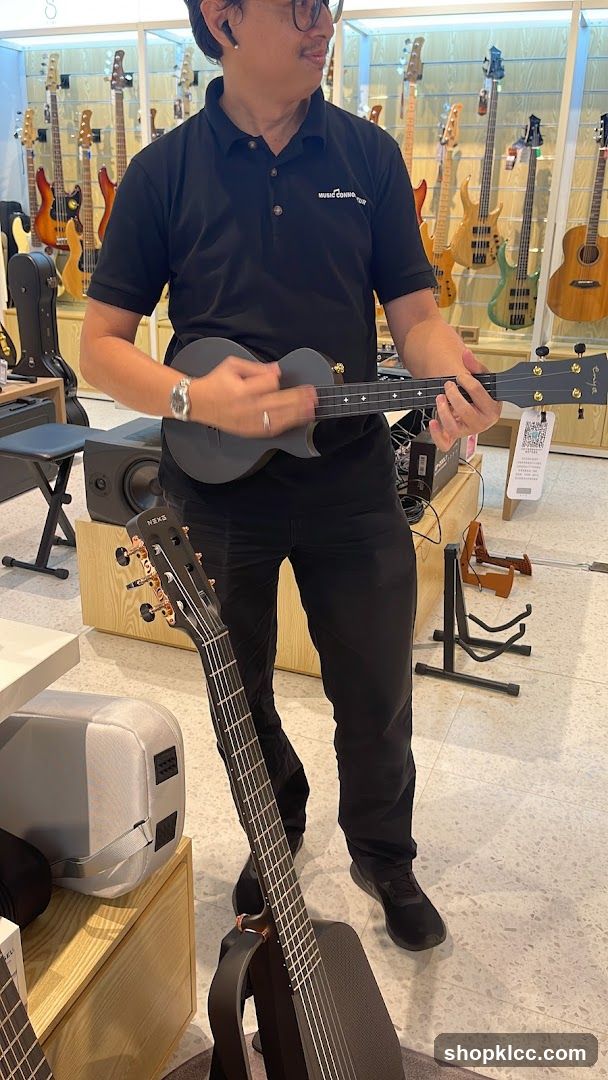 Man playing a ukulele in a music store