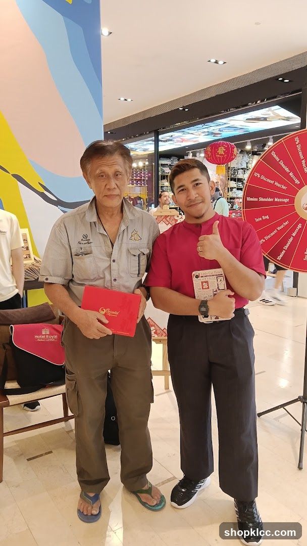 Two men posing with promotional items