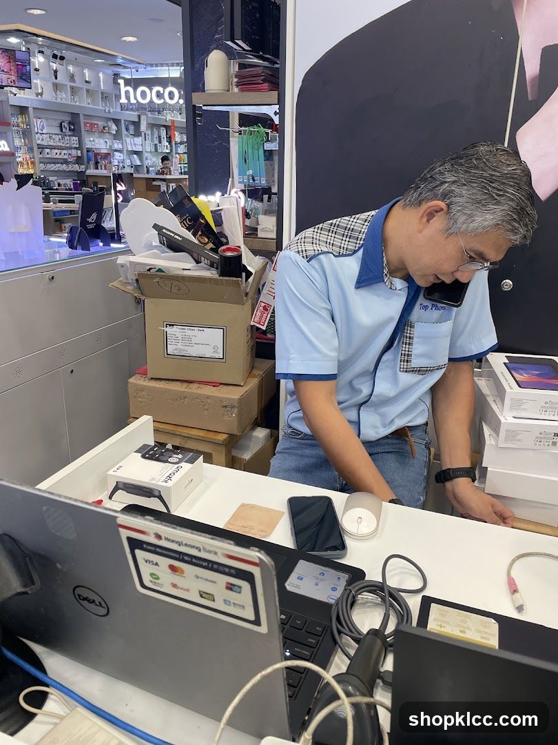 Man on the phone at a store counter
