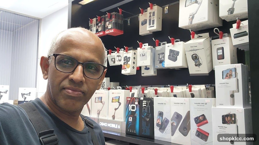 Man in Store with Camera Accessories