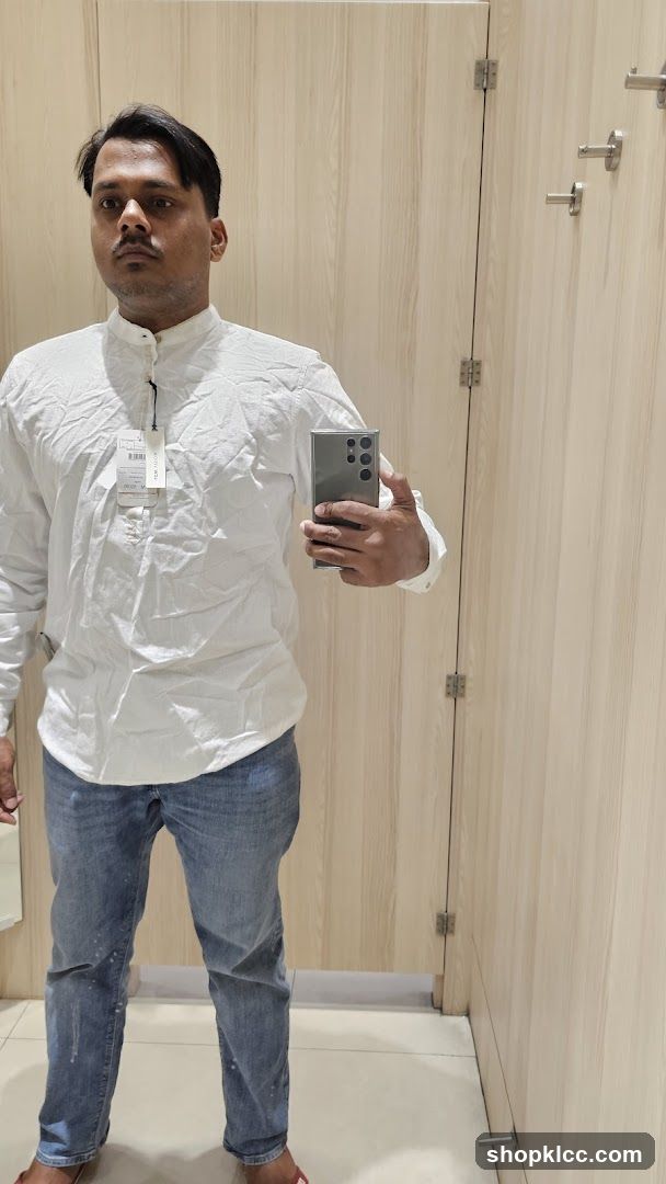 Man trying on clothes in a fitting room