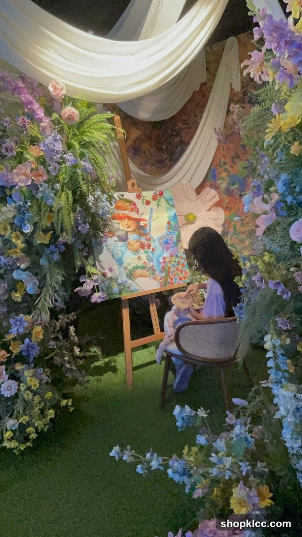 Artist painting in a floral setting