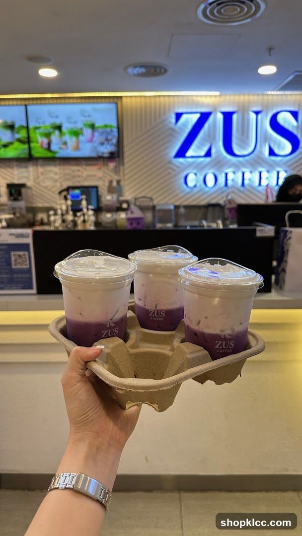Three purple drinks in a carrier