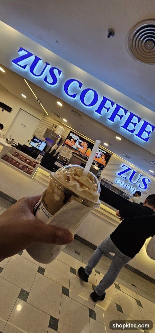 ZUS COFFEE storefront with a drink