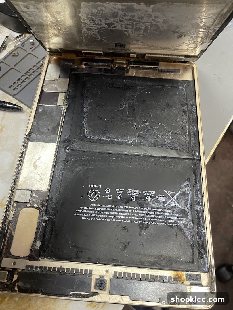 Disassembled Laptop with Damaged Battery