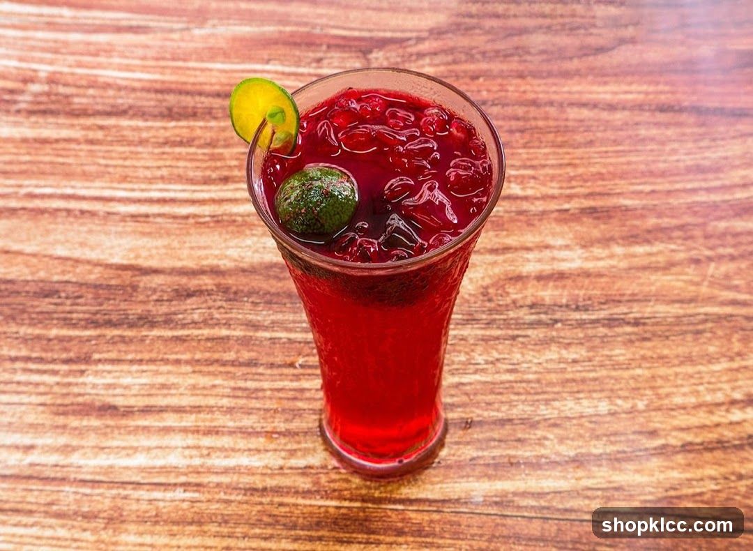 Red Fruit Drink with Lime Garnish