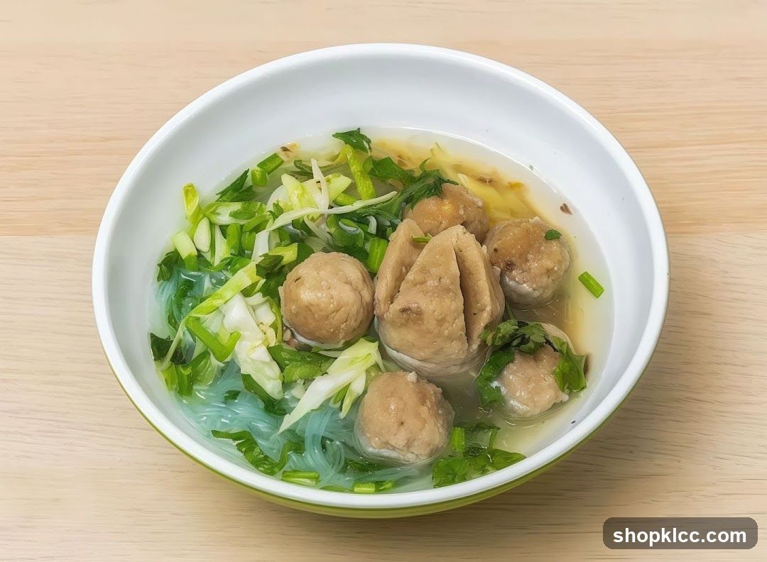 Bowl of Noodle Soup with Meatballs and Greens
