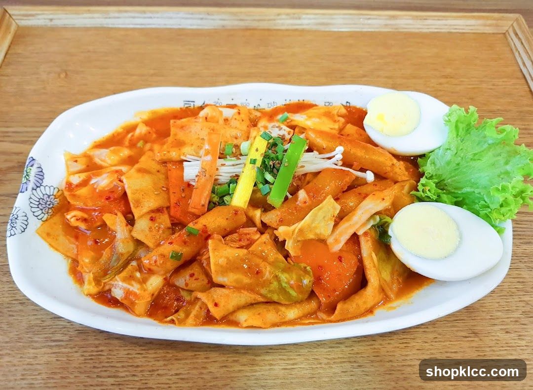Spicy Rice Cake Dish with Boiled Egg and Greens