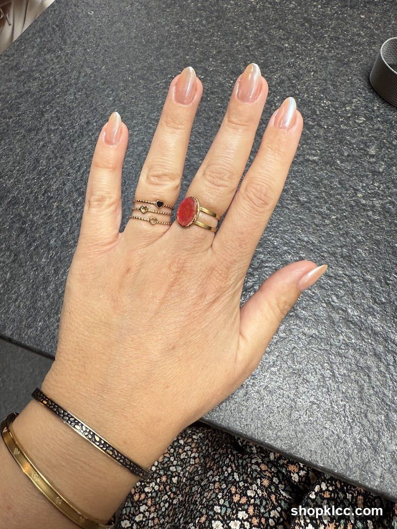 Hand with rings and bracelet on table