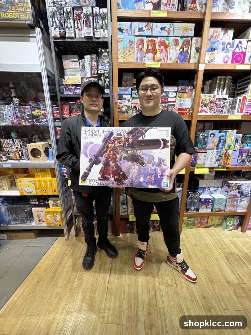 Two men holding a model kit box in a toy store