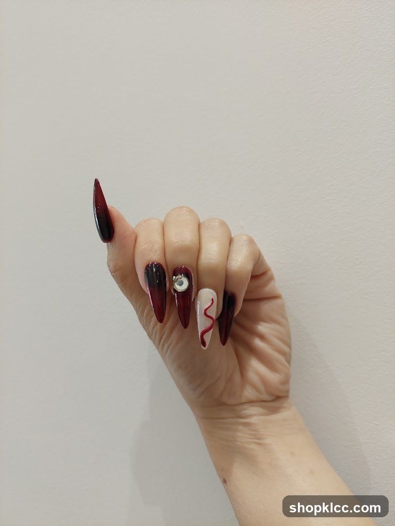 Dark Red Gradient Nail Art with Decorative Elements