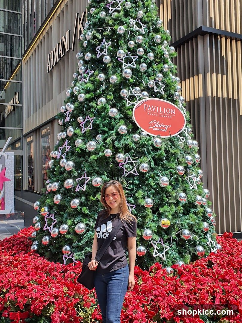 Woman Posing in Front of a Christmas Tree