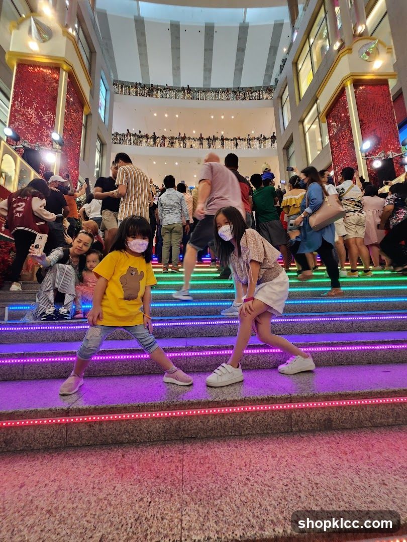 People on illuminated stairs in a mall