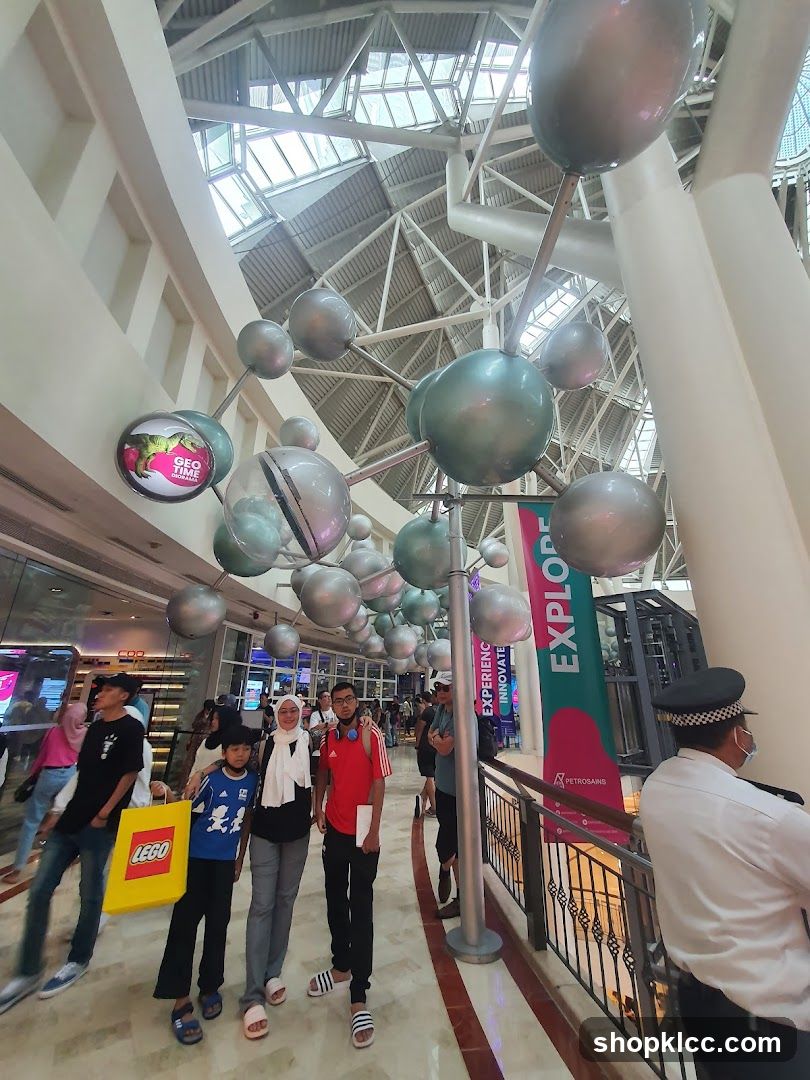 People walking in a mall with molecular decorations