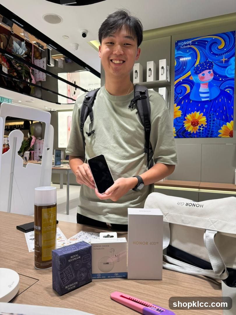 Man holding a phone with Honor products