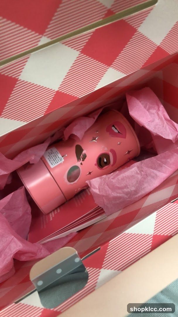 Pink cosmetic bottle in gift bag
