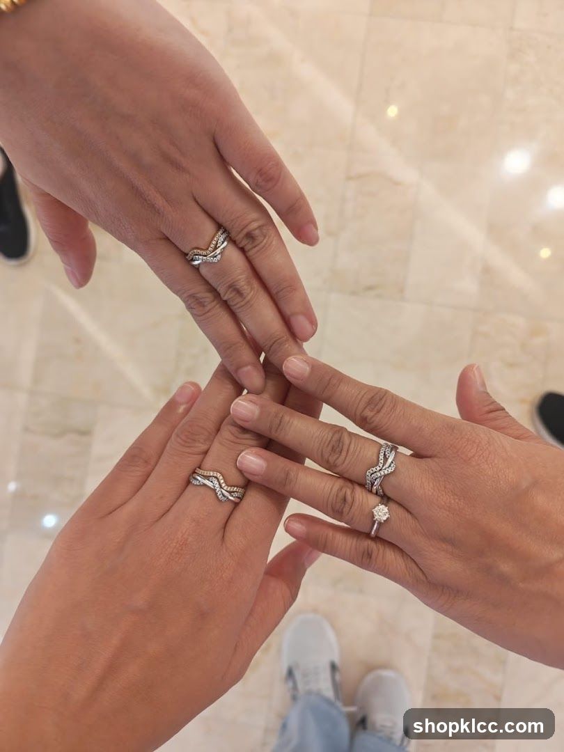 Three hands wearing rings