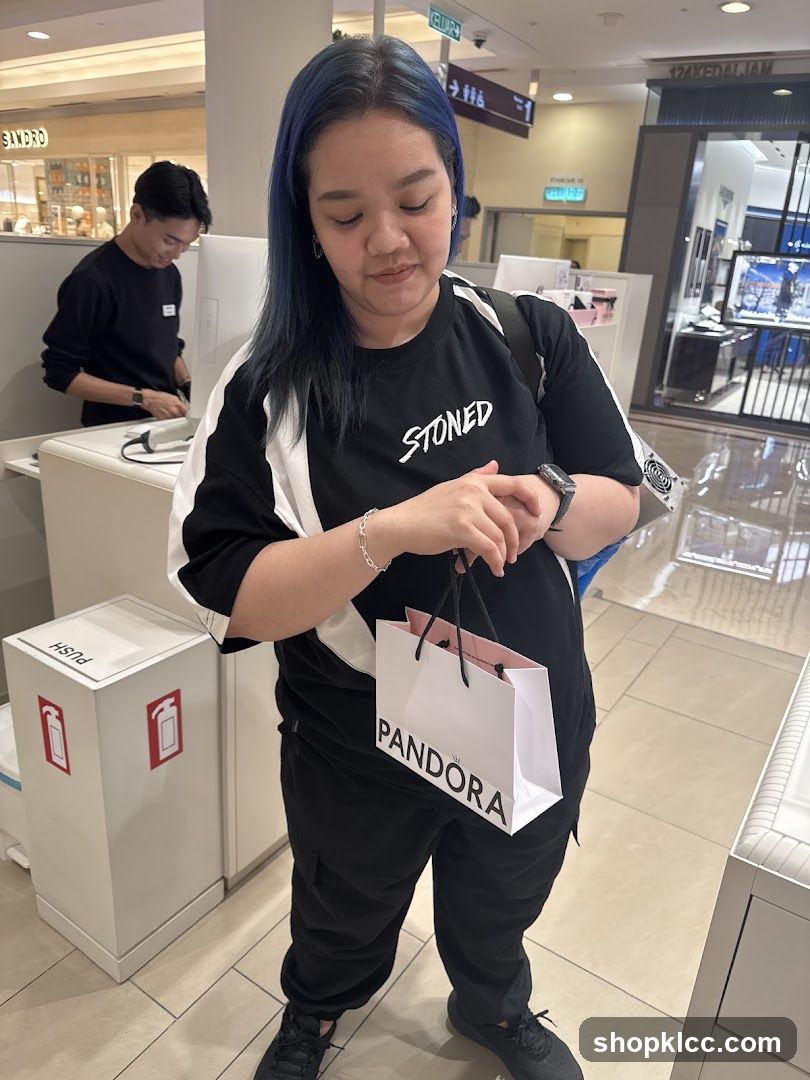Woman holding a Pandora shopping bag