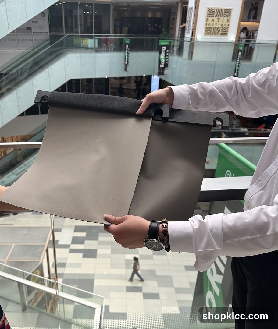 Person holding fabric samples in mall