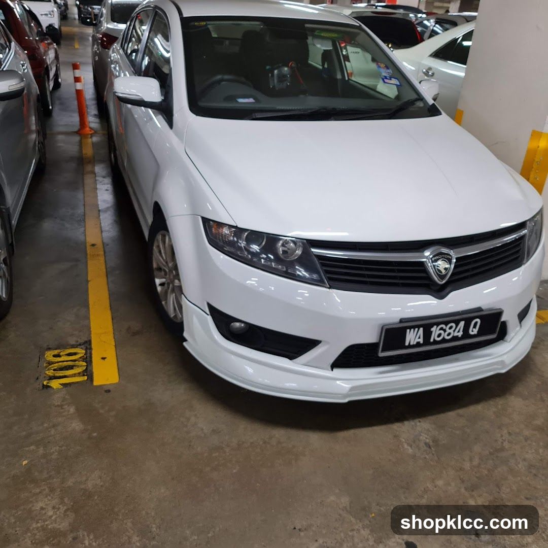 White Proton Car in Parking Lot