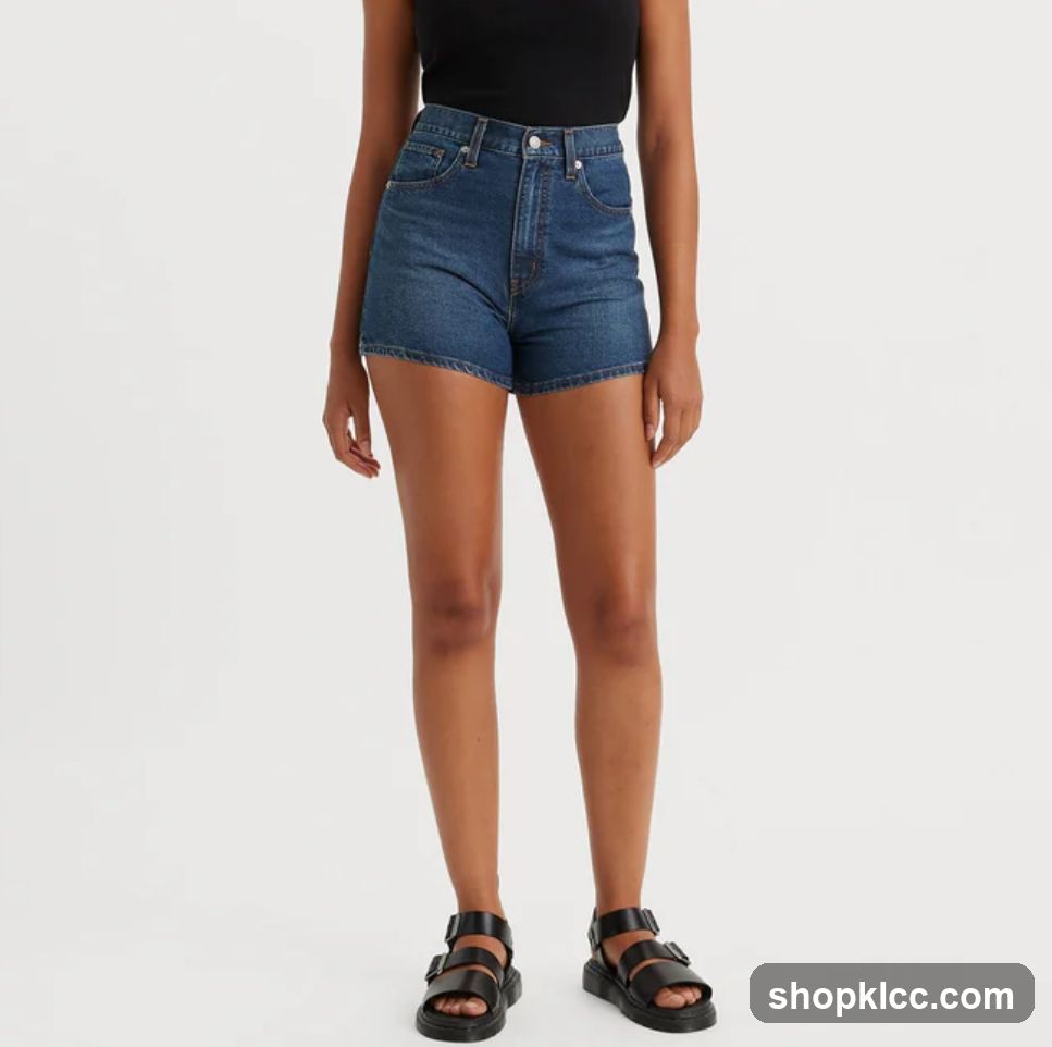 Woman wearing denim shorts and black tank top