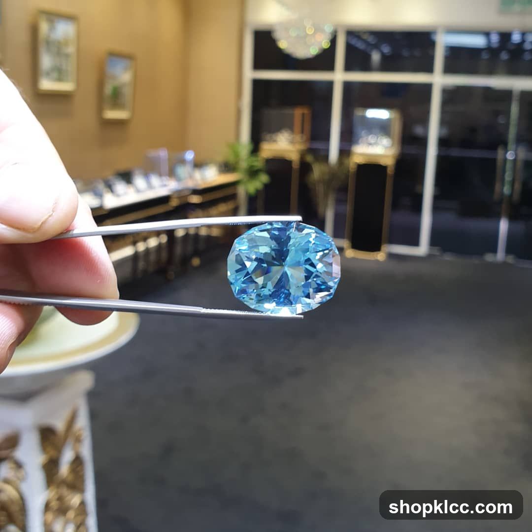 Blue Gemstone Held by Tweezers