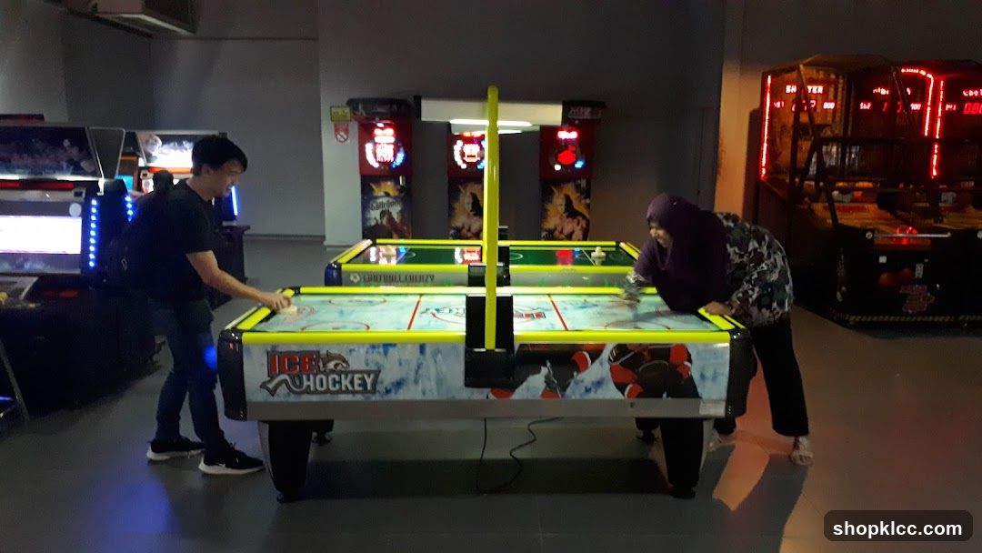 People playing air hockey