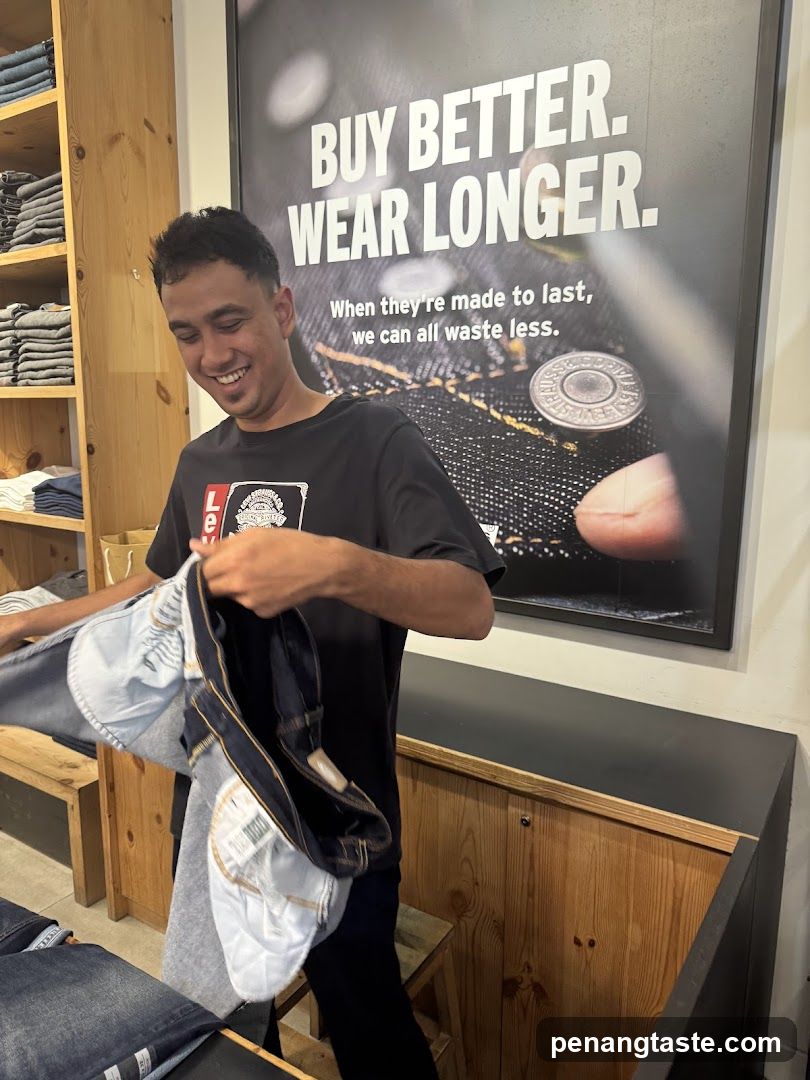 Man holding jeans in a store
